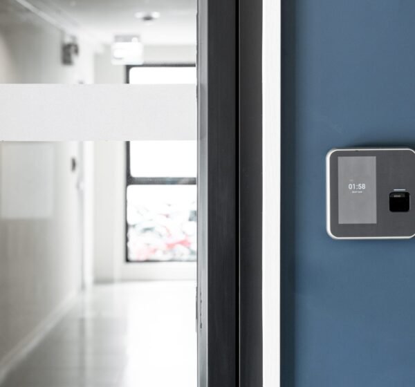 Finger or card scanner device placed on blue wall to unlock the entrance door. Smart home technology Concept