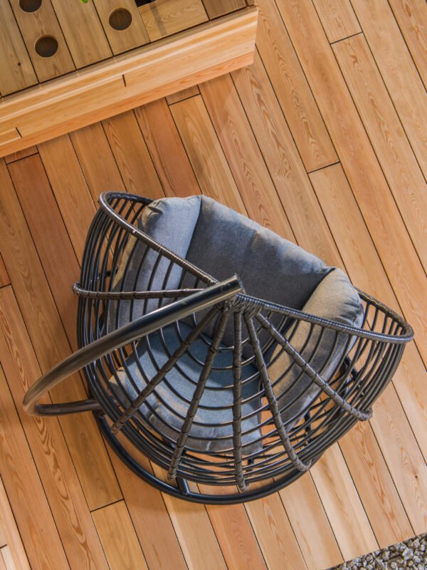 Modern Backyard Garden Wooden Deck, Table and Hanging Comfortable Garden Chair. Top View. Brick and Rocks.