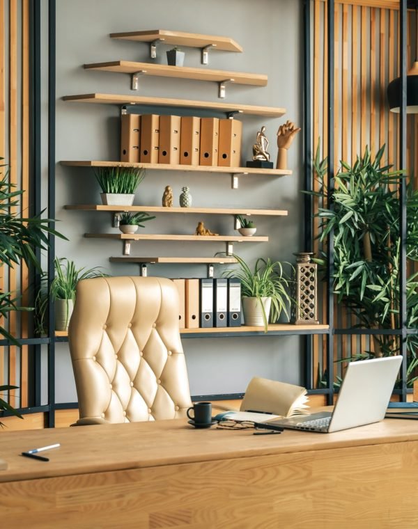 Modern office of general manager, businessman, ceo. Stylish wooden table, leather chair, interior. Workplace, workspace of accountant, financial director. Shelves with documents. Home library.